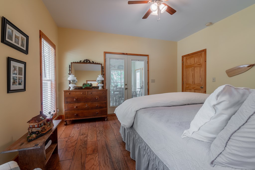 636 Kings Gap Road Hamilton, GA 31811 - Photo 30 of 63 a bedroom with a bed and a chandelier