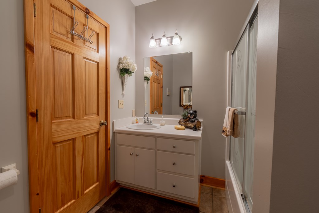 636 Kings Gap Road Hamilton, GA 31811 - Photo 36 of 63 a bathroom with a double vanity sink a mirror and a shower