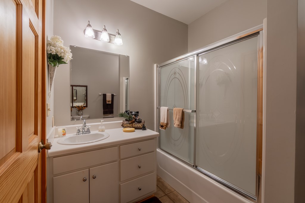 636 Kings Gap Road Hamilton, GA 31811 - Photo 37 of 63 a bathroom with a mirror a sink and shower
