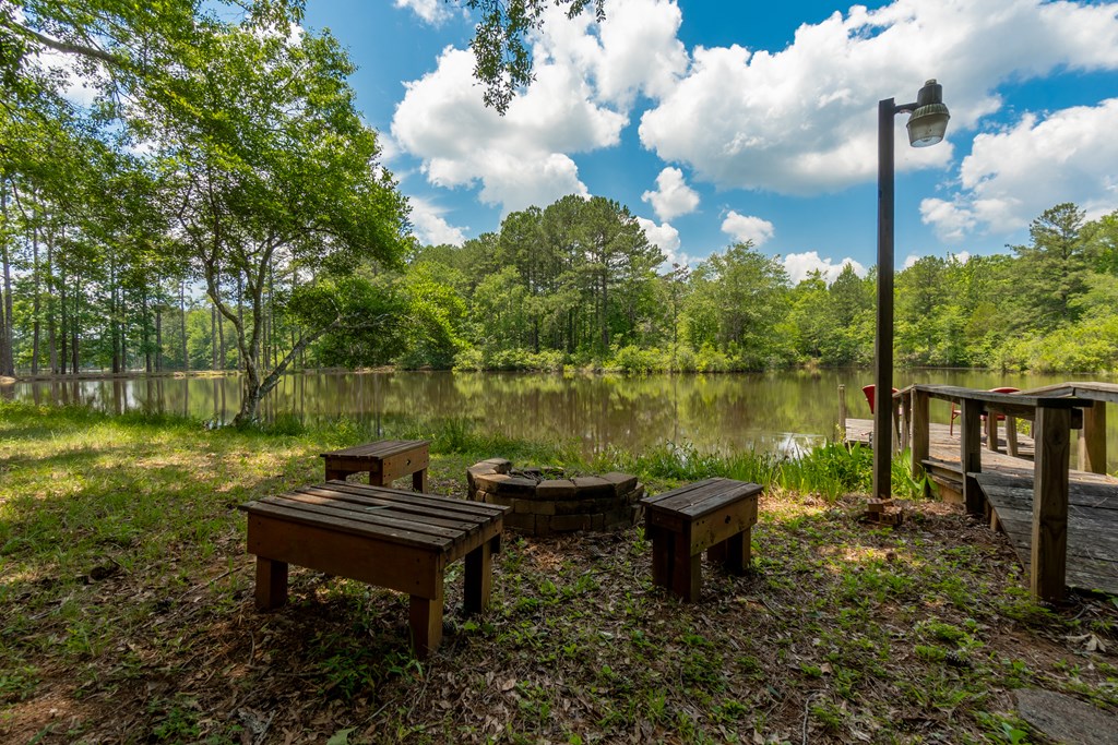 636 Kings Gap Road Hamilton, GA 31811 - Photo 45 of 63 a lake view with a garden and outdoor seating
