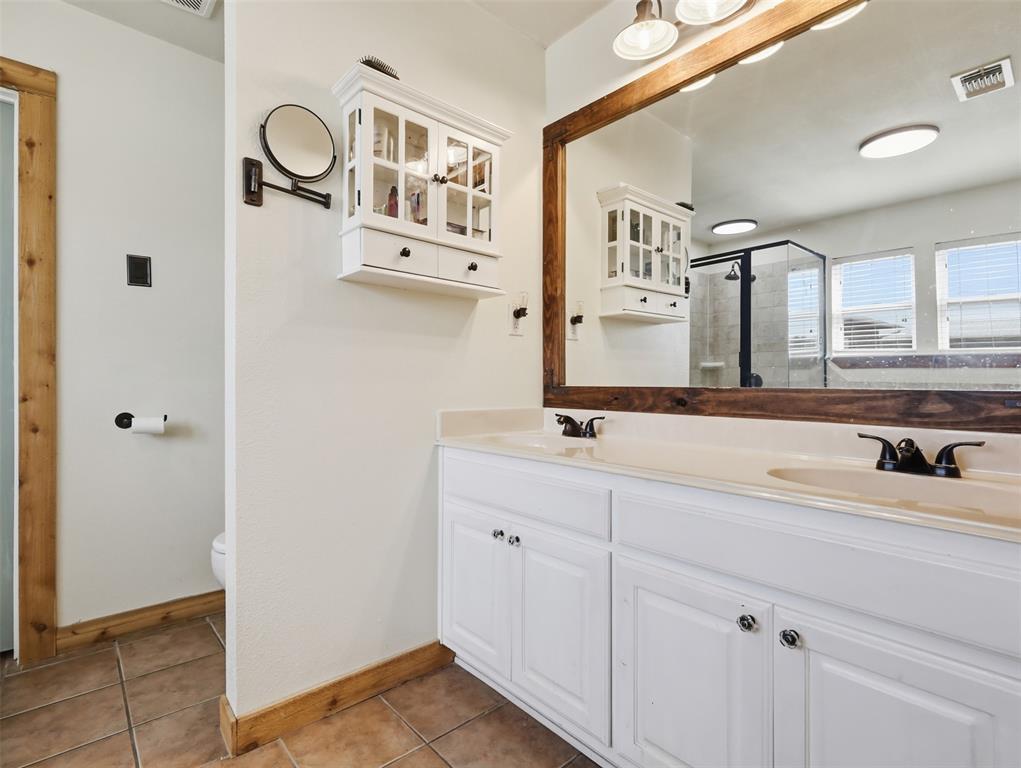 3823 State Highway Bonham, TX 75418 - Photo 14 of 37 a bathroom with a sink and a mirror