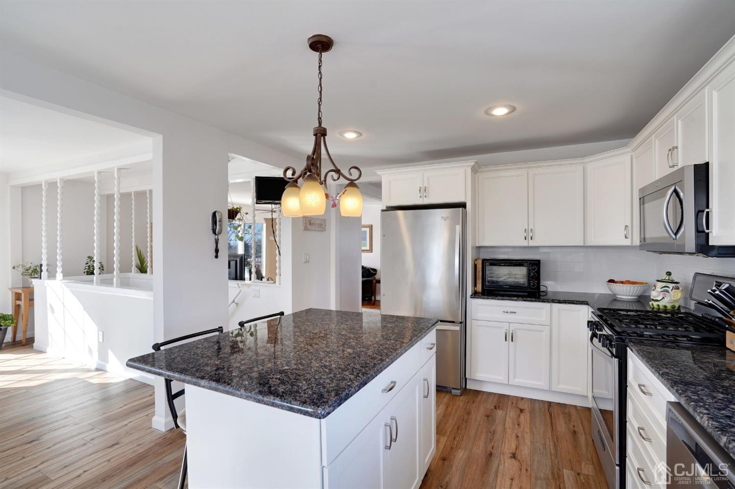 17 Bucknell Road Old Bridge, NJ 08859 - Photo 11 of 28 a kitchen with stainless steel appliances granite countertop a sink a stove and a wooden floors
