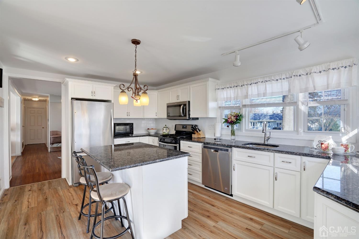 17 Bucknell Road Old Bridge, NJ 08859 - Photo 12 of 28 a kitchen with kitchen island granite countertop a center island a sink stainless steel appliances and cabinets