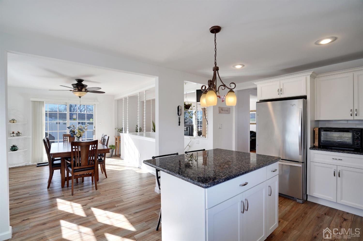 17 Bucknell Road Old Bridge, NJ 08859 - Photo 10 of 28 a kitchen with stainless steel appliances granite countertop a kitchen island a stove a table and chairs