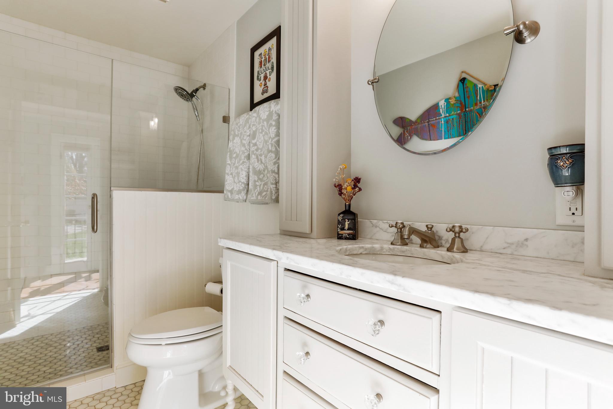 305 College Place Frederick, MD 21701 - Photo 29 of 71 a bathroom with a granite countertop sink a toilet and a mirror