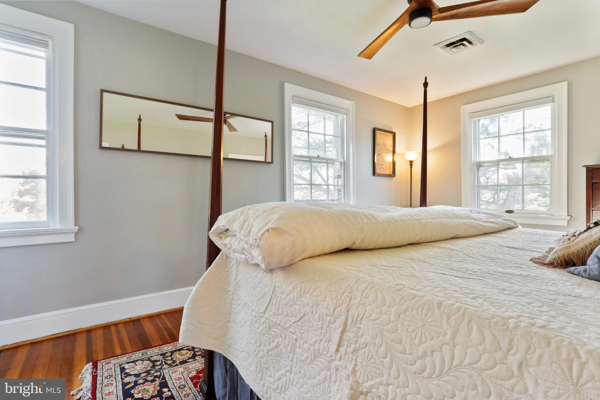 305 College Place Frederick, MD 21701 - Photo 33 of 71 a bedroom with a bed next to a window with a chandelier
