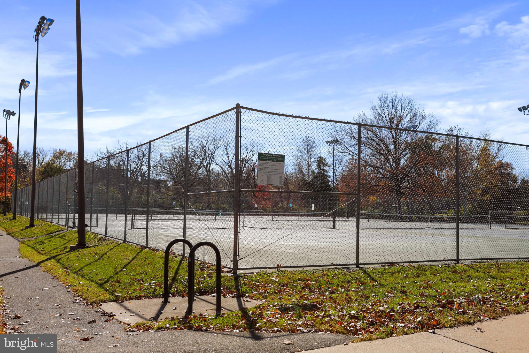305 College Place Frederick, MD 21701 - Photo 66 of 71 a view of a swimming pool with a bench and wooden fence