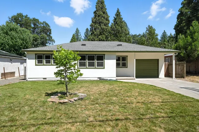 a house that has a tree in front of it