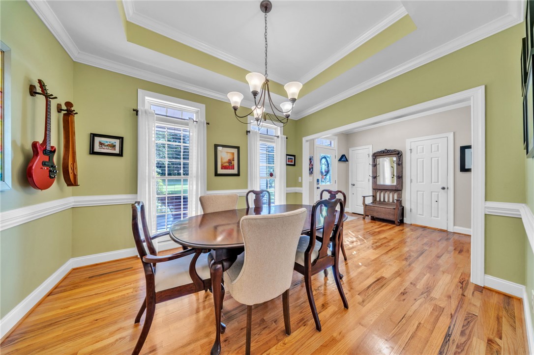 648 Mountain View Road Williamston, SC 29697 - Photo 9 of 42 A refined dining space features gleaming hardwood floors and a striking tray ceiling.