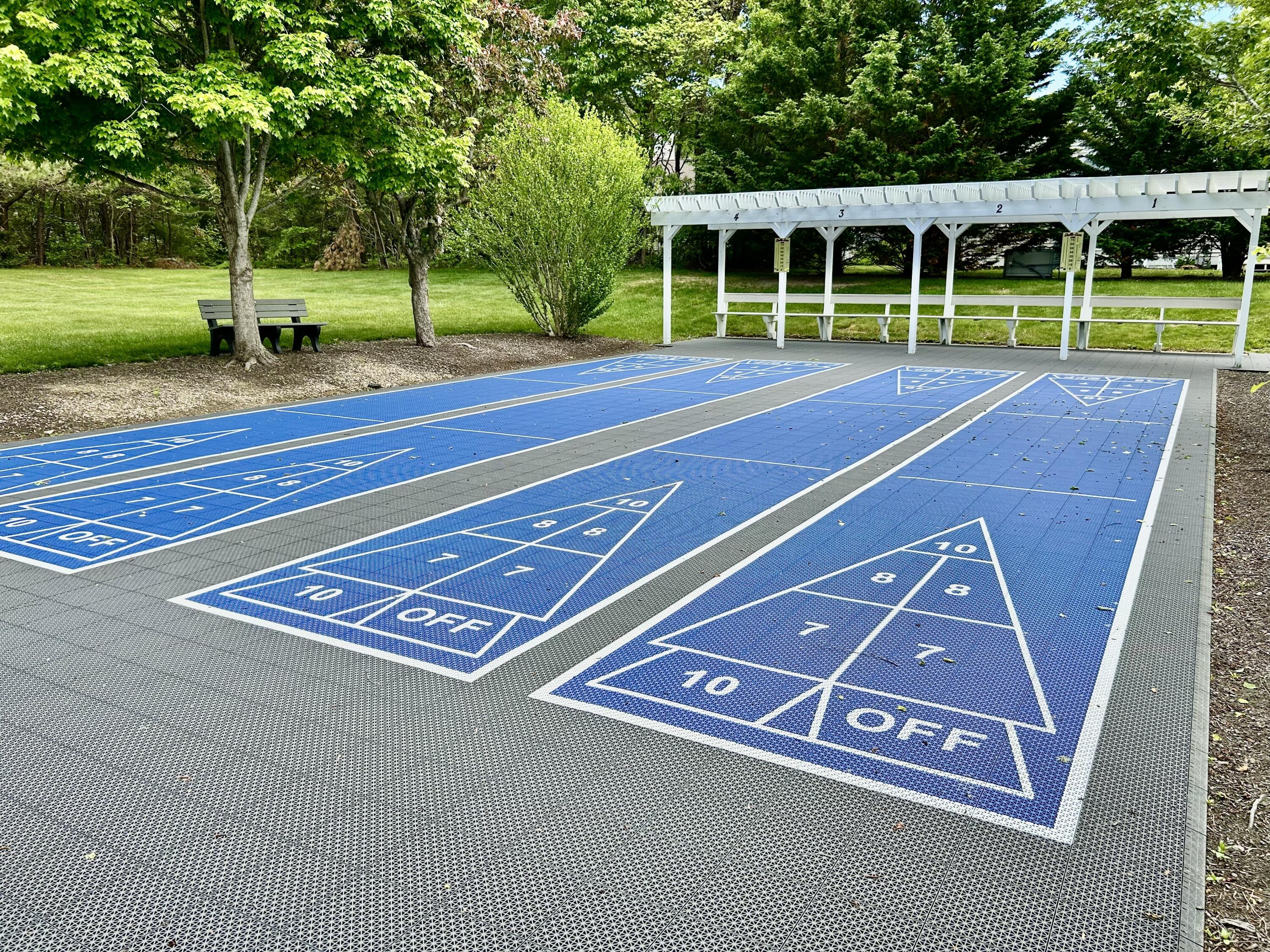 28 Windward Street, Unit 28 Mashpee, MA 02649 - Photo 28 of 37 a view of a tennis ground with large trees