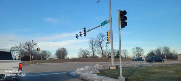a street sign on a sidewalk next to a road