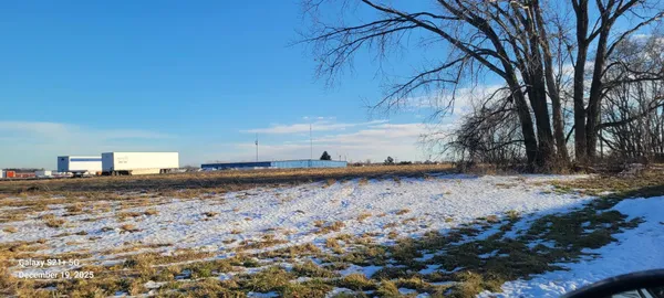 a view of a dry yard with trees