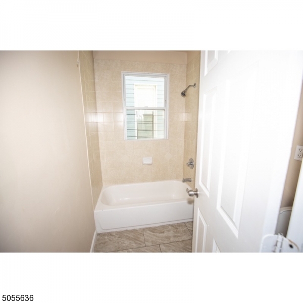 54 3rd Street, Unit 3 Newark, NJ 07107 - Photo 11 of 12 a bathroom with a tub and shower
