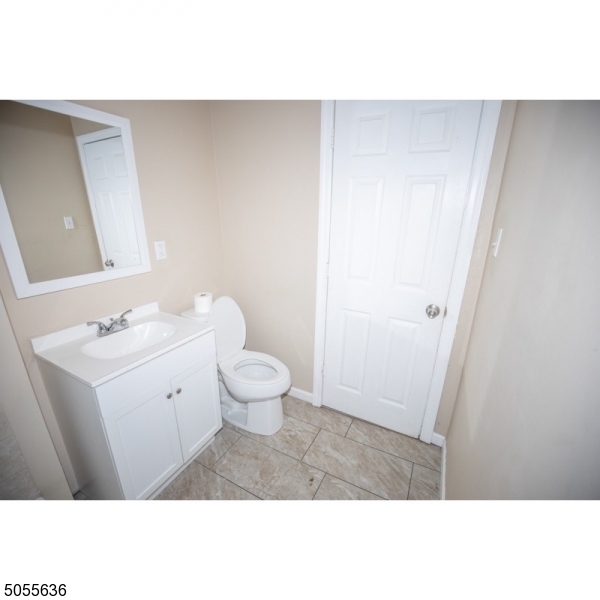 54 3rd Street, Unit 3 Newark, NJ 07107 - Photo 12 of 12 a bathroom with a sink a toilet and a mirror