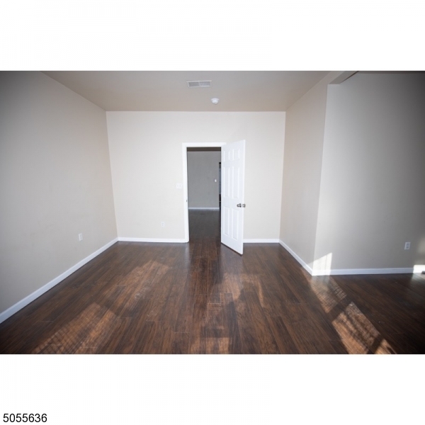54 3rd Street, Unit 3 Newark, NJ 07107 - Photo 9 of 12 a open area with wooden floor