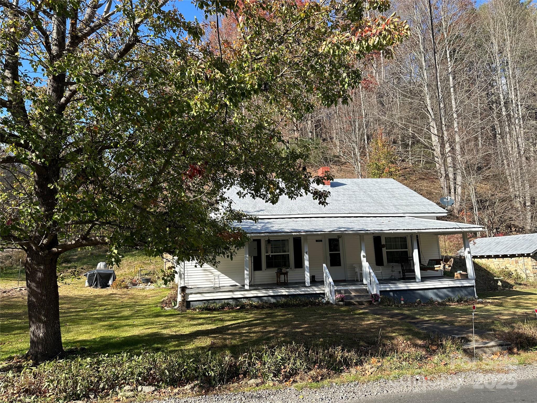2812 Bald Mountain Road Burnsville, NC 28714 - Photo 16 of 38 a front view of a house with swimming pool and porch with furniture