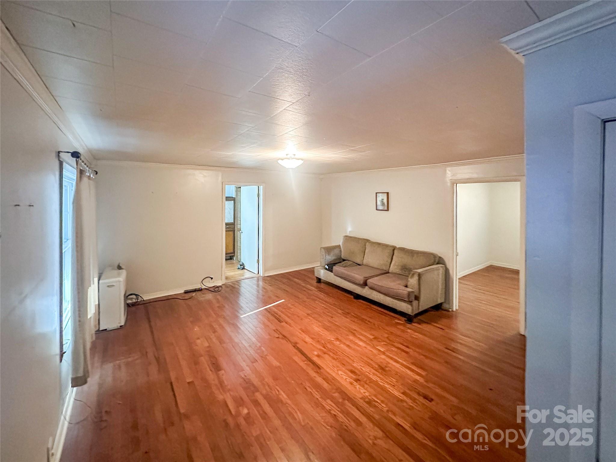 2812 Bald Mountain Road Burnsville, NC 28714 - Photo 17 of 38 a living room with furniture and a wooden floor