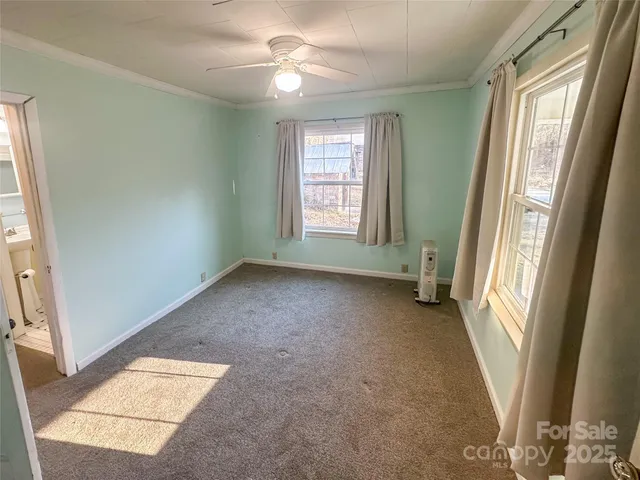 a view of staircase with railing and white walls