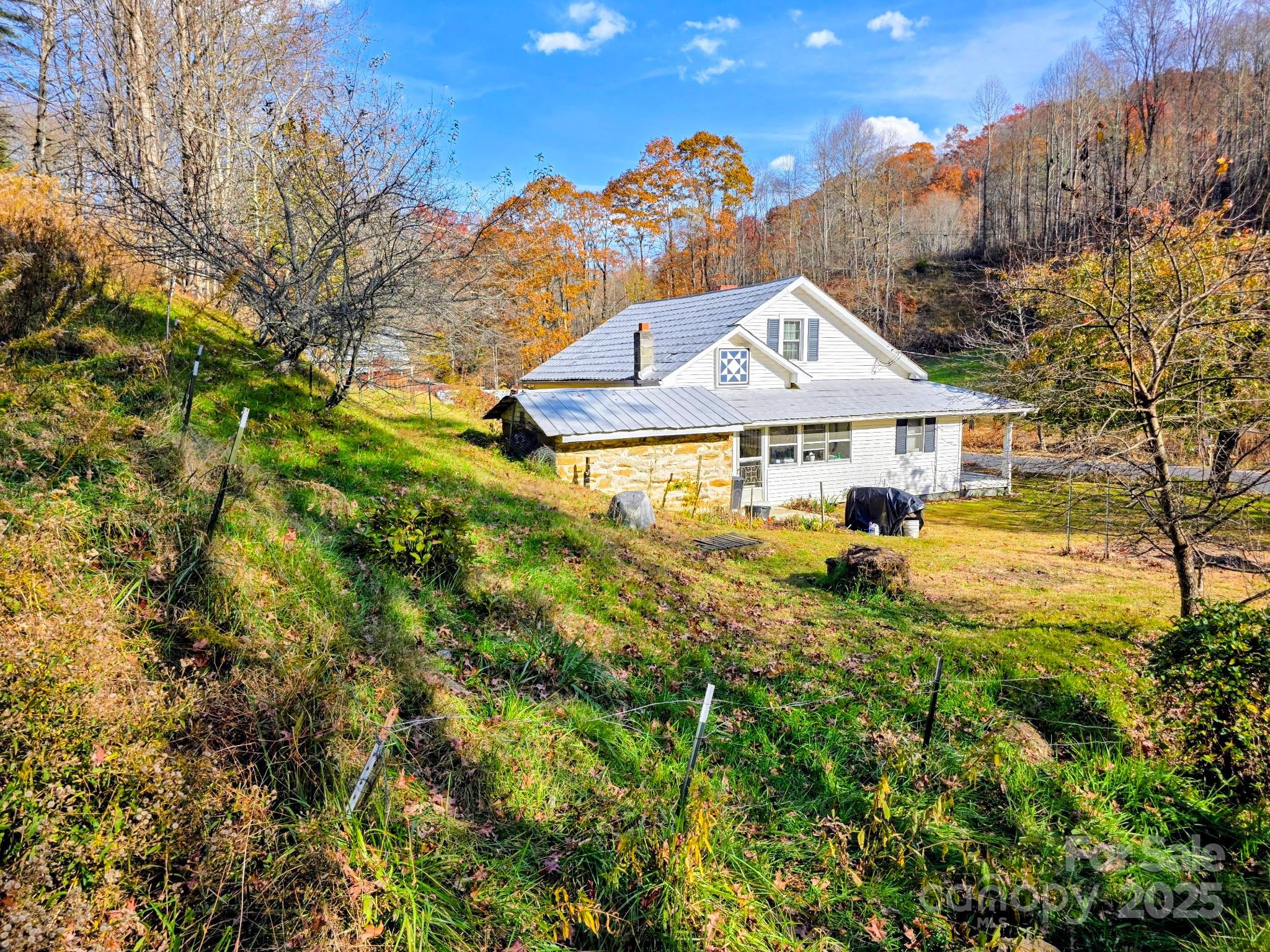 2812 Bald Mountain Road Burnsville, NC 28714 - Photo 2 of 38 a view of a house with a yard and sitting area