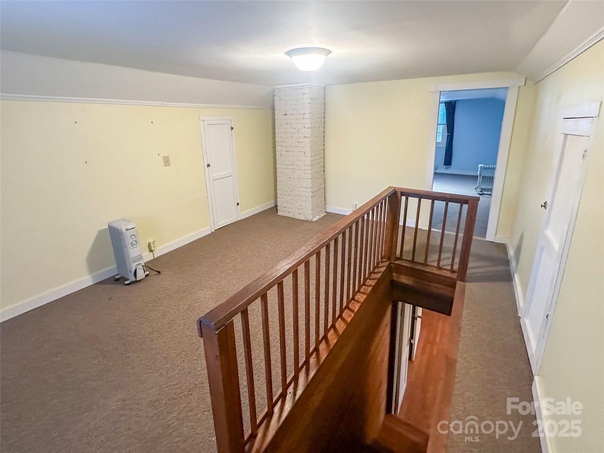 2812 Bald Mountain Road Burnsville, NC 28714 - Photo 29 of 38 a view of staircase with railing and white walls