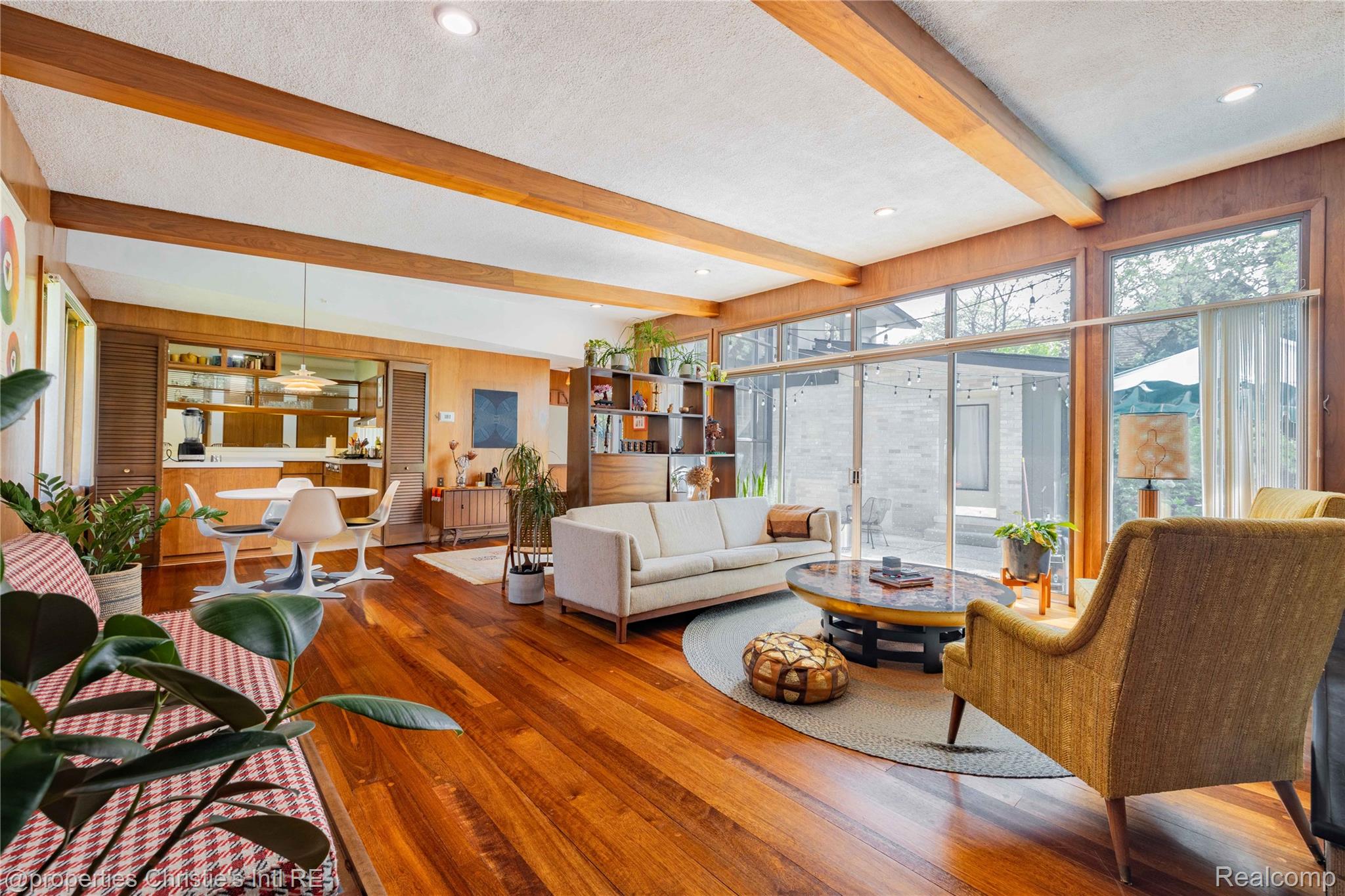 2771 West Seven Mile Road Detroit, MI 48221 - Photo 10 of 57 Spacious living area featuring exposed wood beams, expansive wood-finish flooring, and a wall of windows