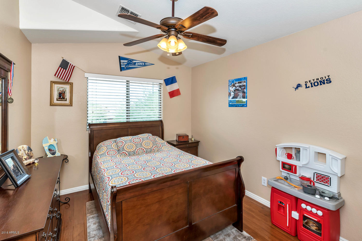 28615 North Nobel Road Phoenix, AZ 85085 - Photo 16 of 27 a bedroom with a bed and a chandelier