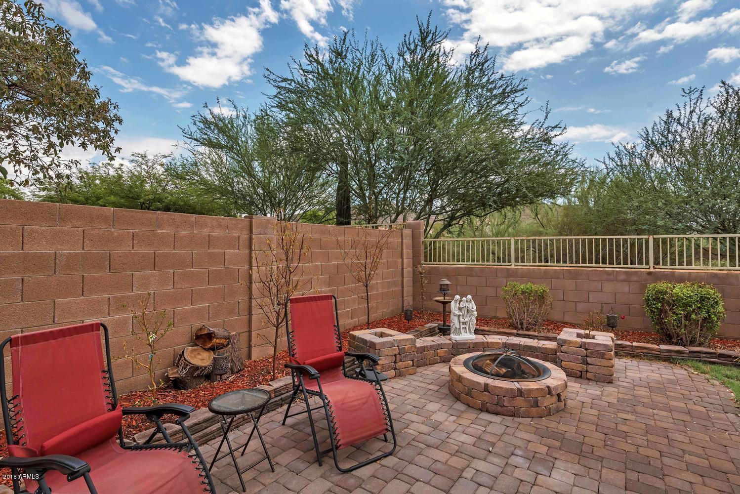 28615 North Nobel Road Phoenix, AZ 85085 - Photo 25 of 27 a backyard of a house with fire pit and outdoor seating
