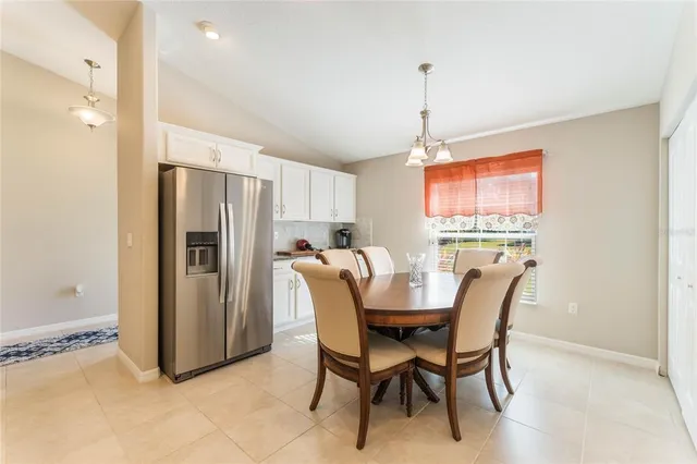a dining room with furniture a window and stainless steel appliances