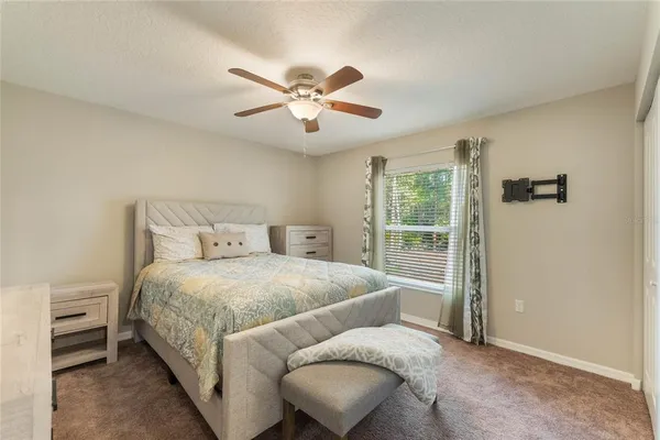 a bedroom with a large bed and a chandelier
