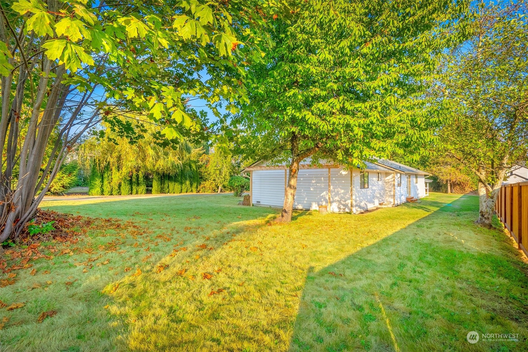2411 Cedar Road Lake Stevens, WA 98258 - Photo 25 of 36 a yellow house with trees in front of it