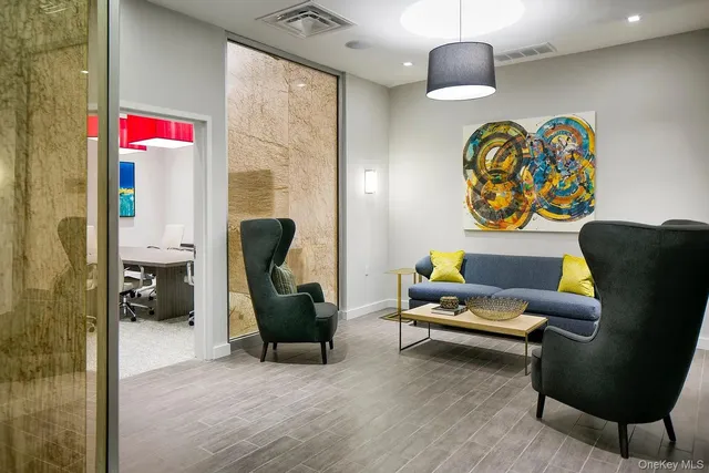 a living room with furniture and a lamp