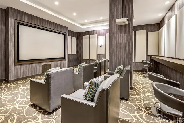 a living room with furniture a flat screen tv and a large window