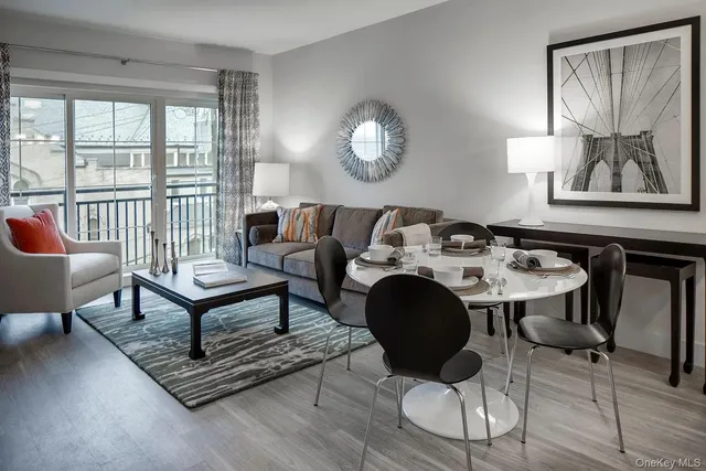 a view of a dining room with furniture a chandelier and wooden floor