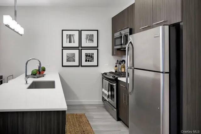 a kitchen with stainless steel appliances a refrigerator and a sink