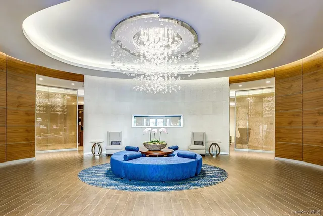 a living room with furniture and a chandelier