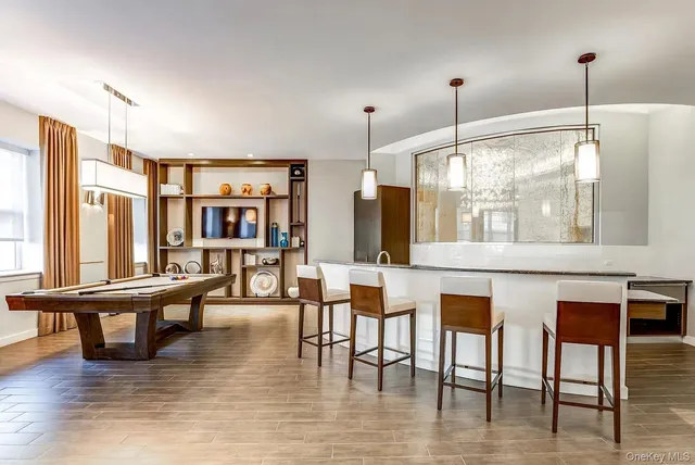 a dining room with furniture window and wooden floor