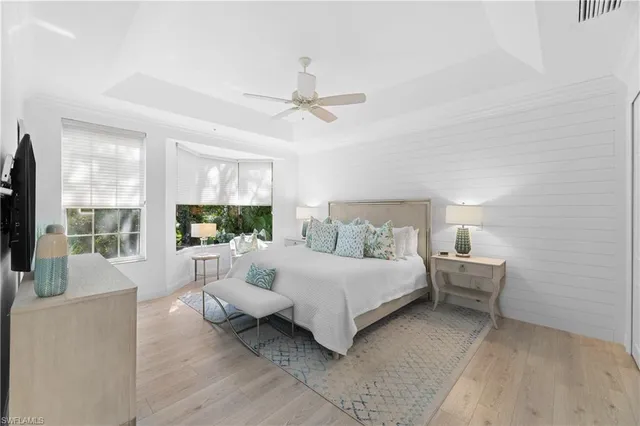 a bedroom with a large bed and a large window