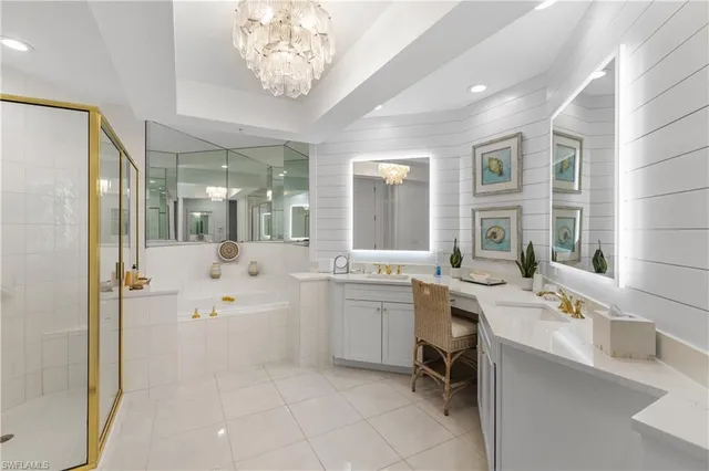 a bathroom with a granite countertop sink mirror and bathtub