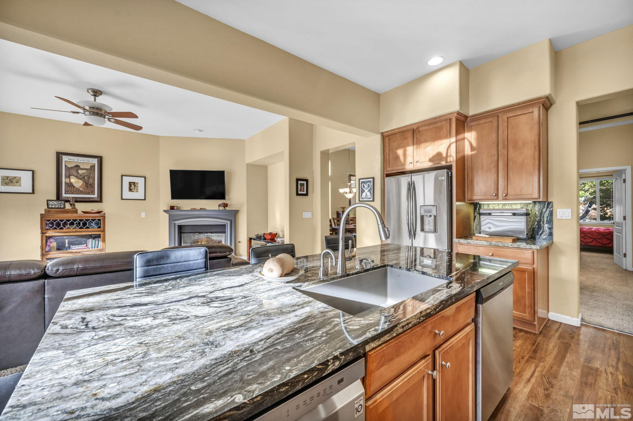 10655 Autumn Walk Lane Reno, NV 89521 - Photo 11 of 40 a kitchen with granite countertop a sink and a counter top space