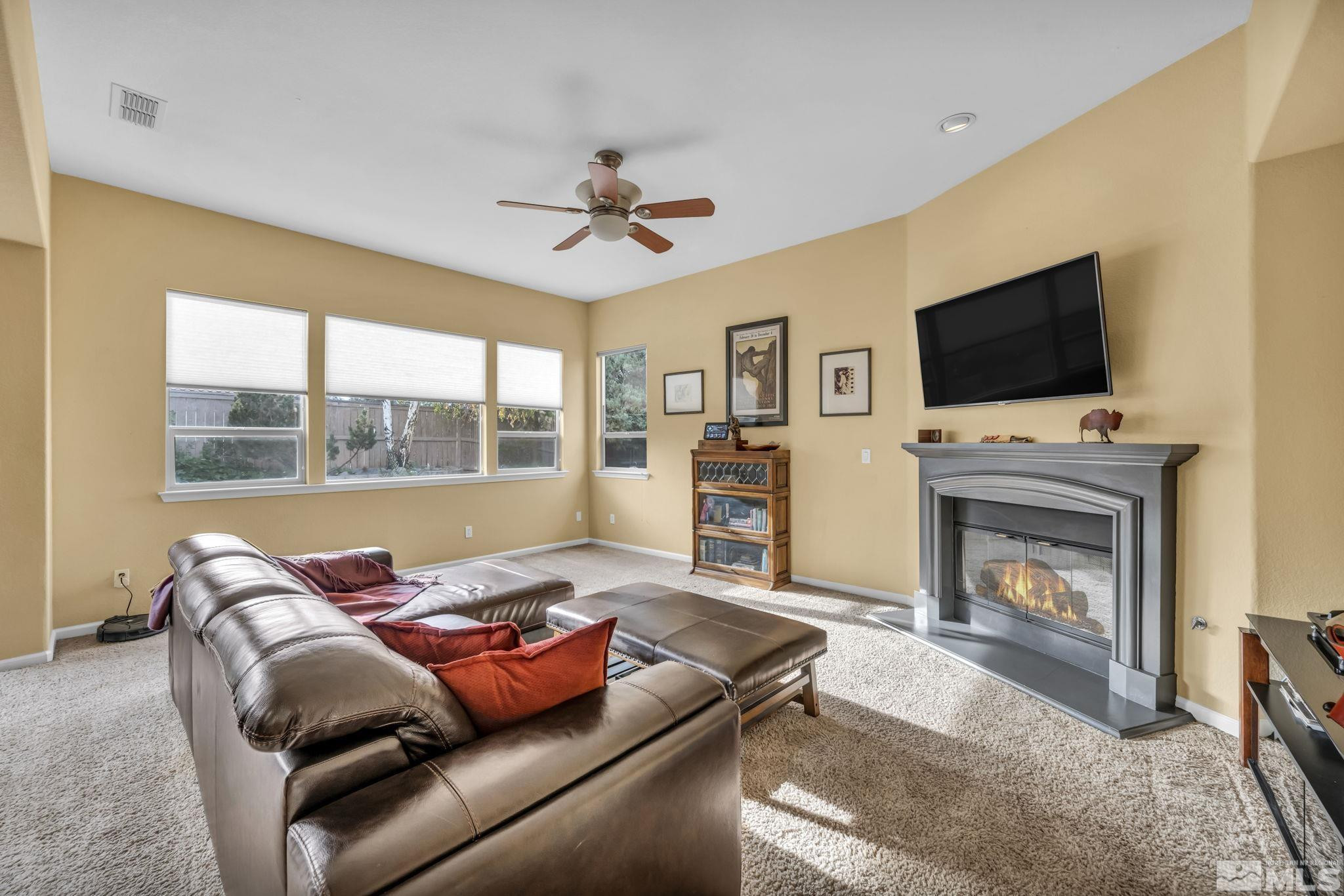 10655 Autumn Walk Lane Reno, NV 89521 - Photo 13 of 40 a living room with furniture a flat screen tv and a fireplace