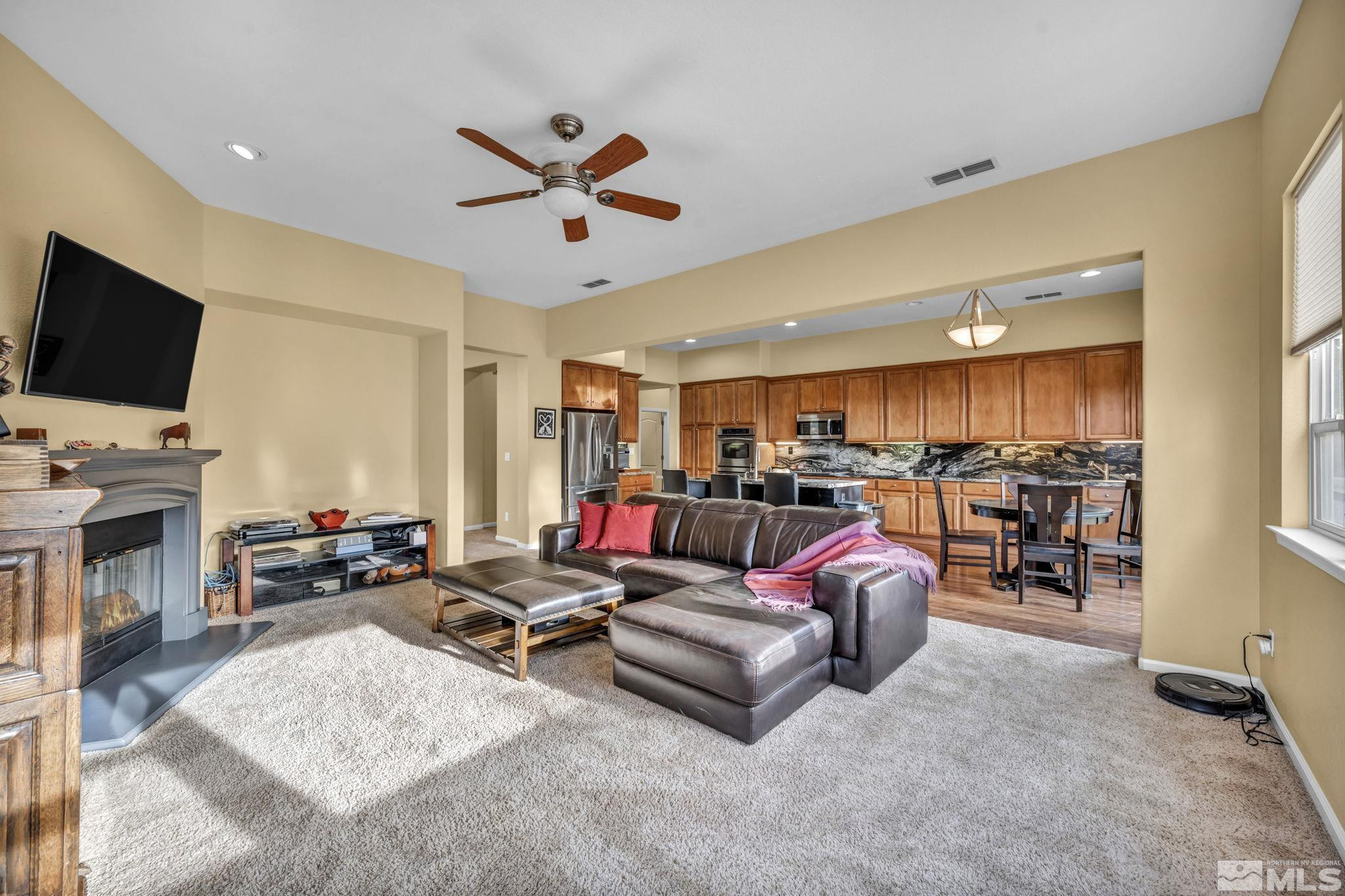 10655 Autumn Walk Lane Reno, NV 89521 - Photo 14 of 40 a living room with furniture and a flat screen tv with kitchen view