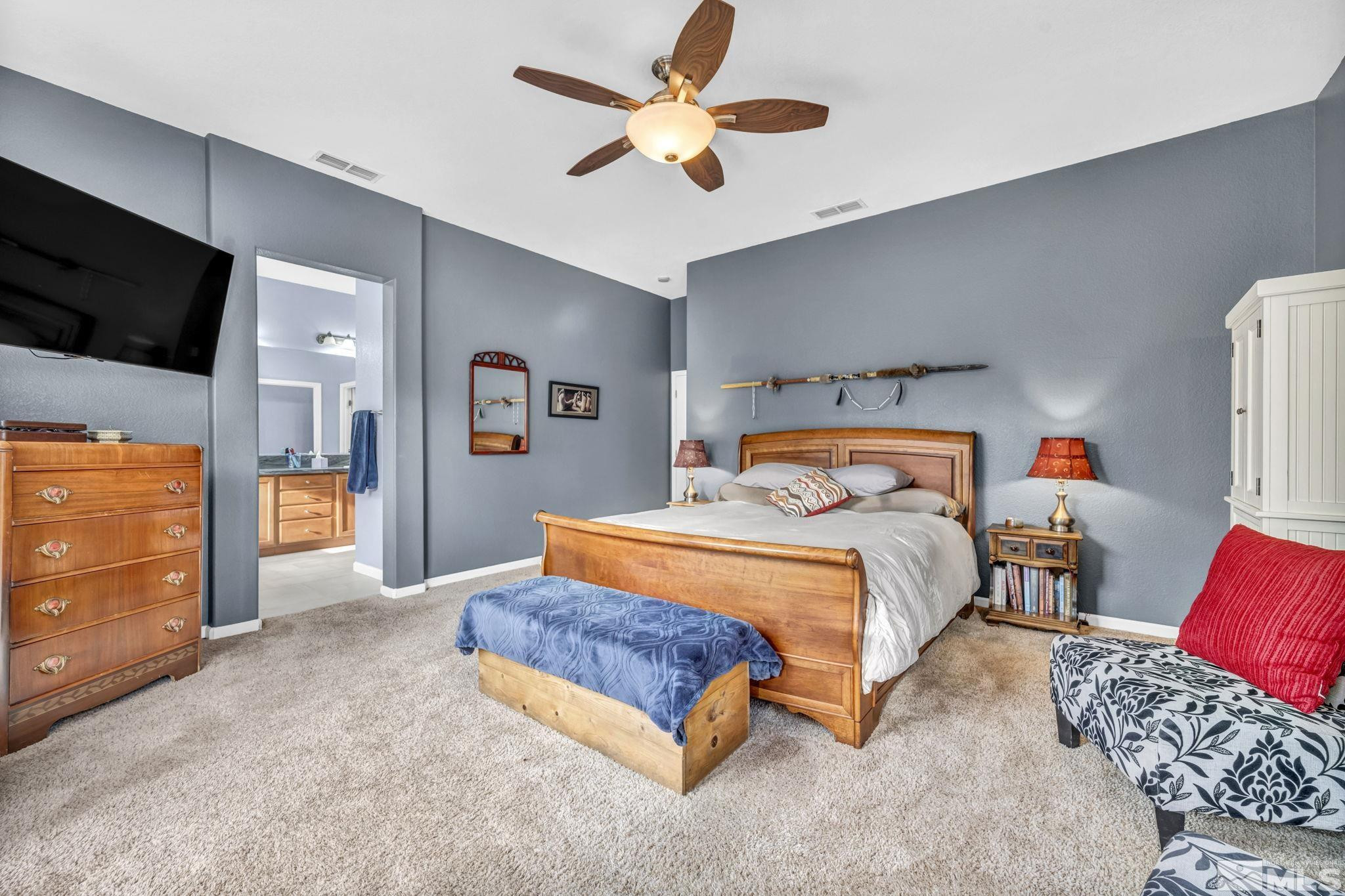 10655 Autumn Walk Lane Reno, NV 89521 - Photo 19 of 40 a bedroom with a bed and a television