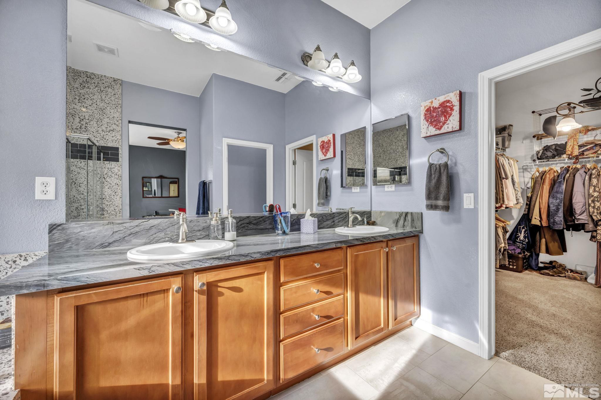10655 Autumn Walk Lane Reno, NV 89521 - Photo 20 of 40 a bathroom with sinks granite countertop a sink and a mirror