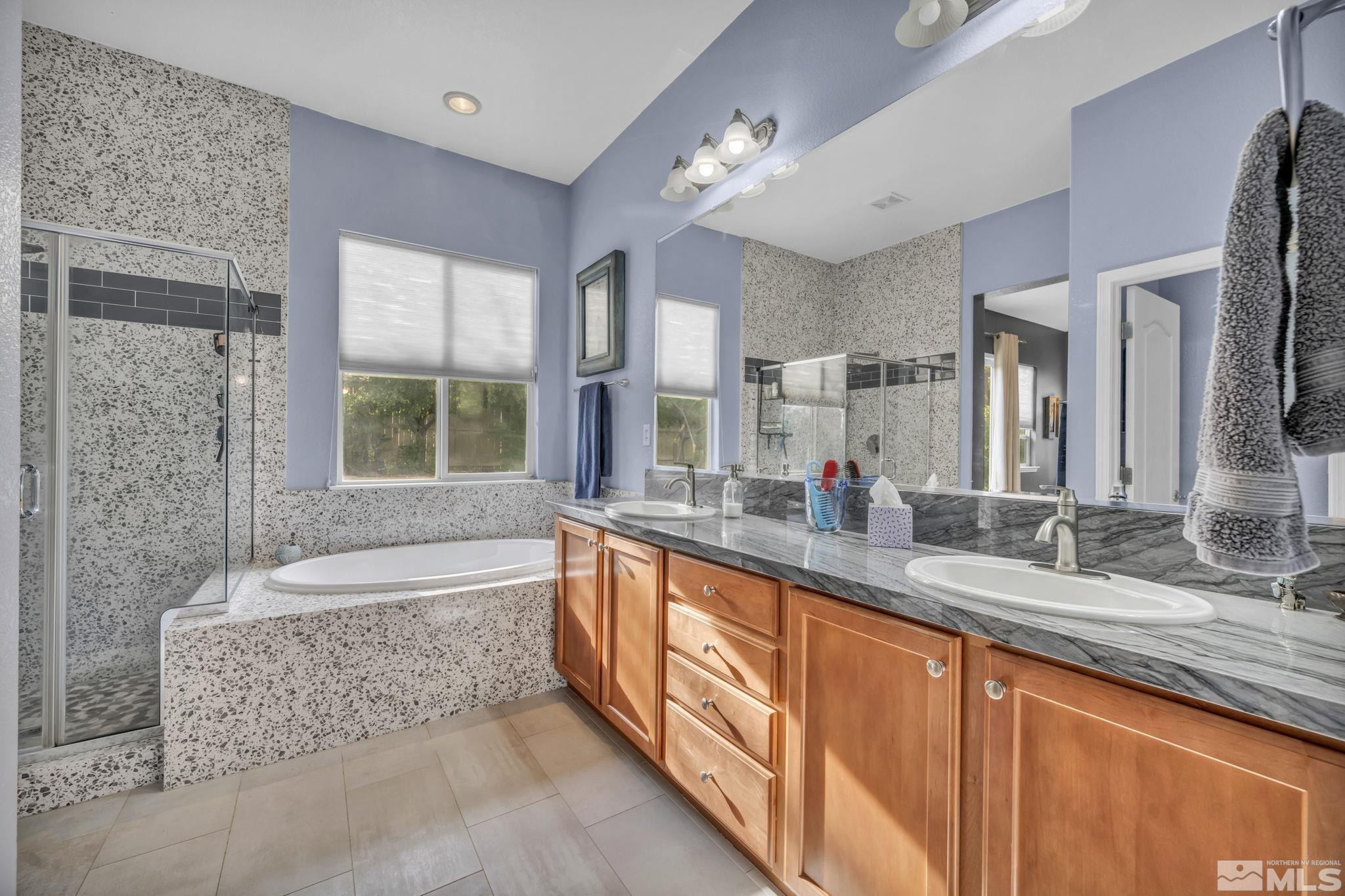 10655 Autumn Walk Lane Reno, NV 89521 - Photo 22 of 40 a spacious bathroom with sinks mirror and a bath tub