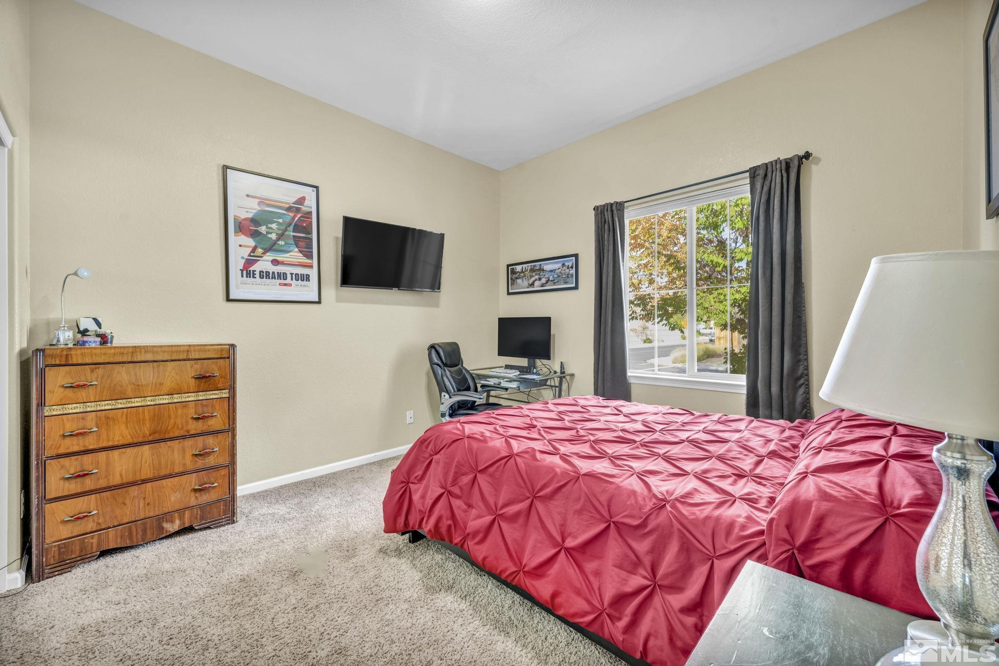 10655 Autumn Walk Lane Reno, NV 89521 - Photo 27 of 40 a bedroom with a bed and a television