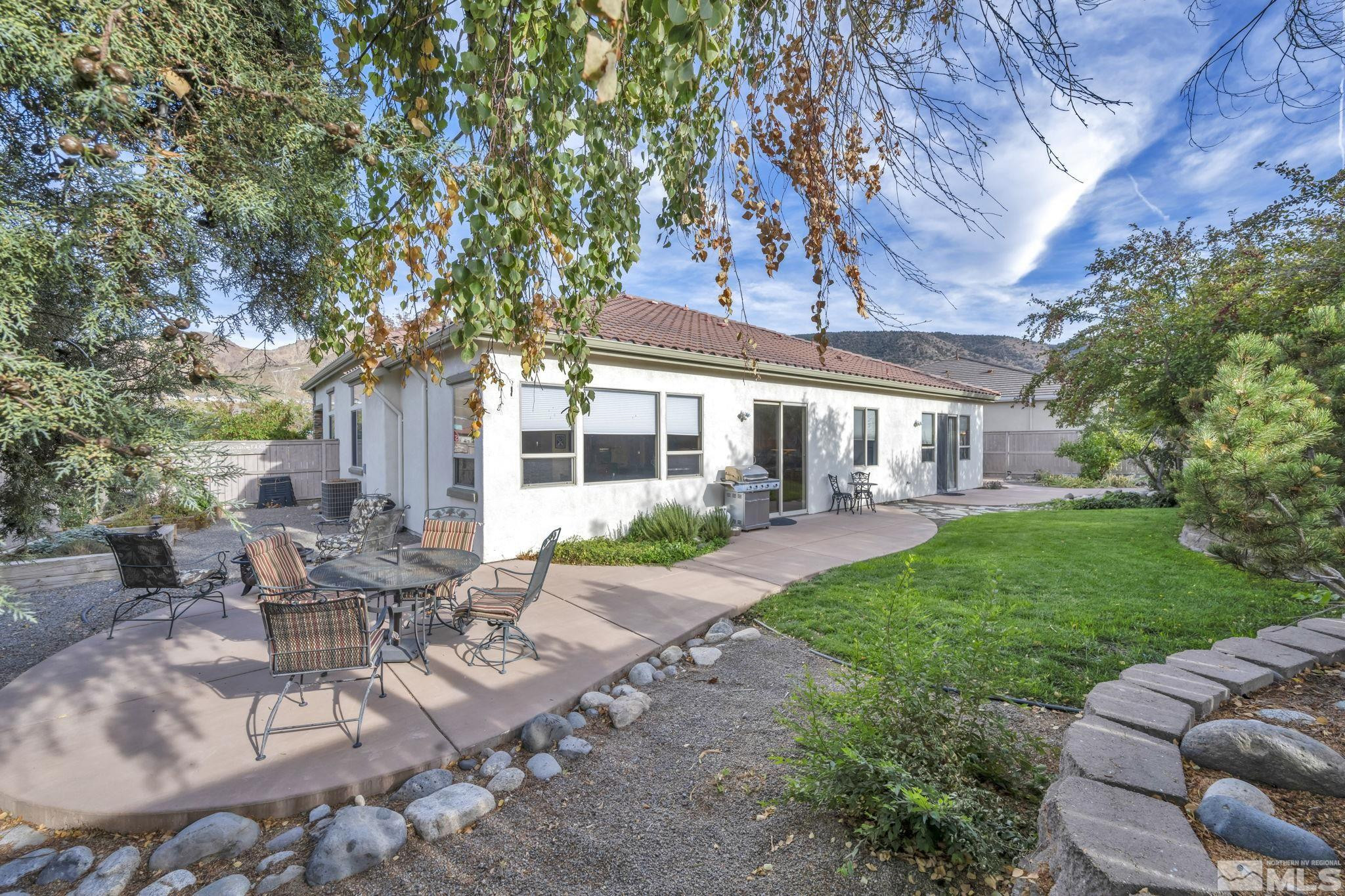 10655 Autumn Walk Lane Reno, NV 89521 - Photo 31 of 40 a view of a house with backyard sitting area and garden