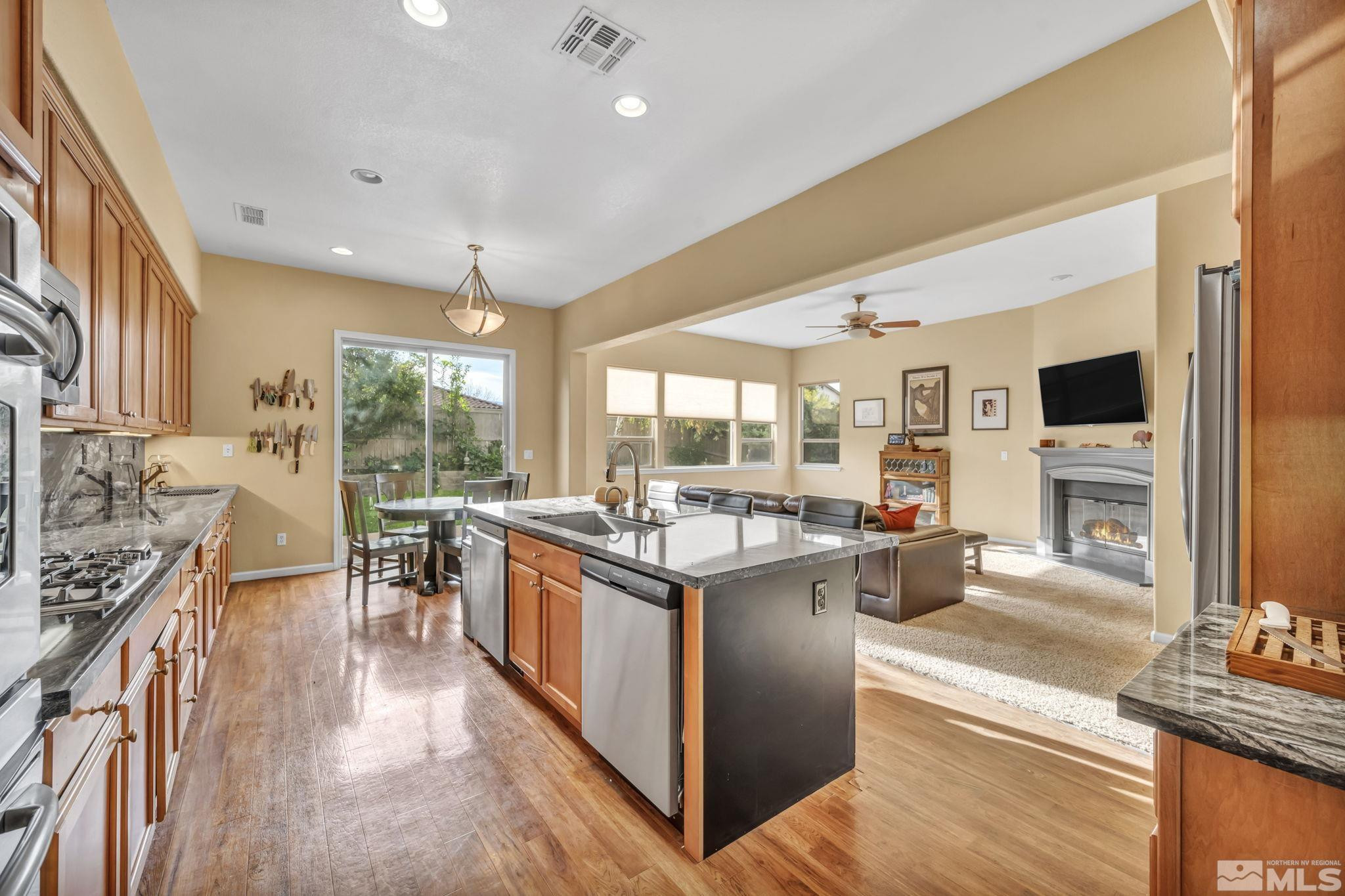 10655 Autumn Walk Lane Reno, NV 89521 - Photo 5 of 40 a kitchen with stainless steel appliances granite countertop a stove and cabinets
