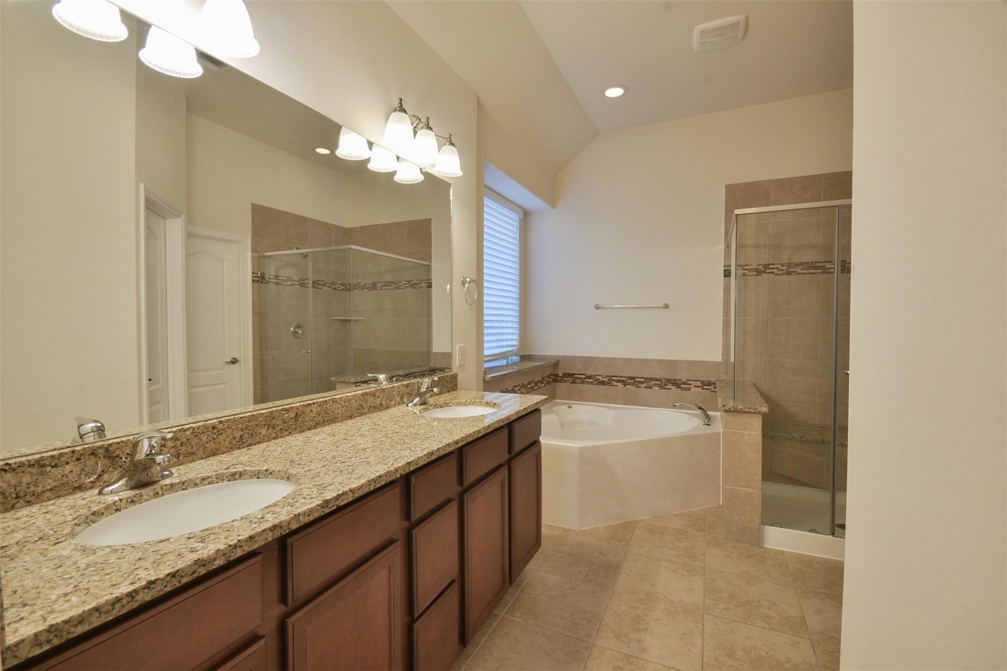 3643 Cottage Pines Lane Spring, TX 77386 - Photo 18 of 33 a bathroom with a granite countertop sink a large mirror and a bathtub