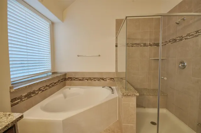 a bathroom with a tub and shower