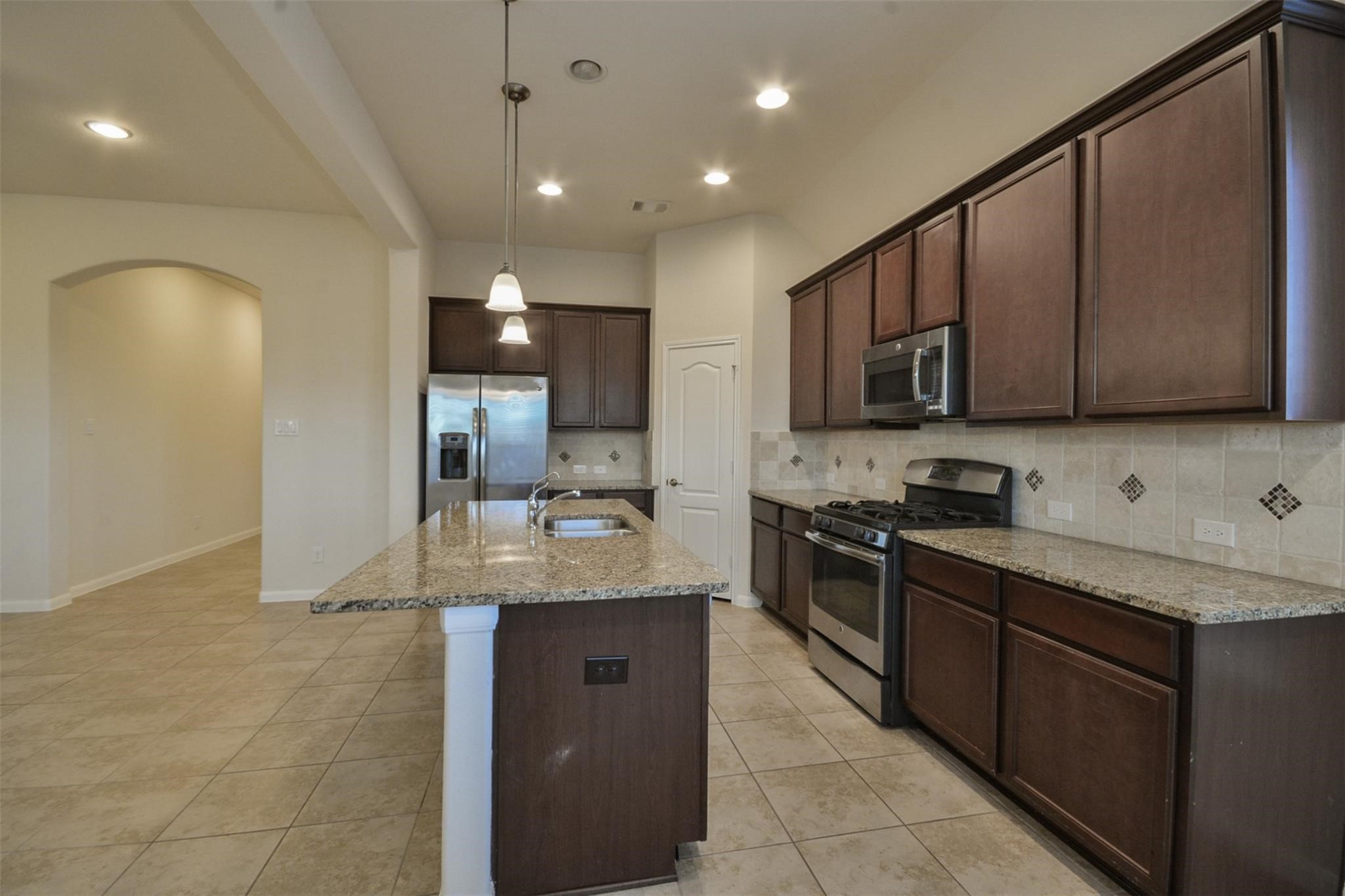 3643 Cottage Pines Lane Spring, TX 77386 - Photo 6 of 33 a large kitchen with stainless steel appliances granite countertop a sink a stove and a refrigerator